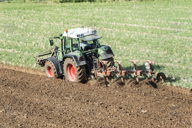 Breuberg, hessen, Germany, farmer with tractor while plowing.