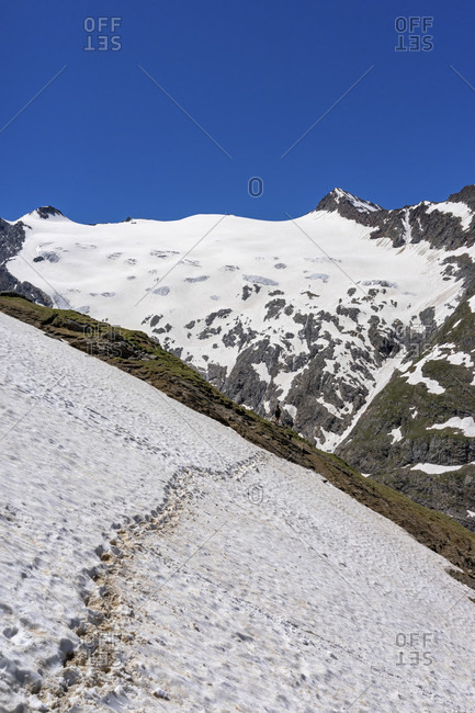 Europe, austria, tyrol, otztal alps, otztal, hiker behind a steep old snow field in front of the rotmoosferner