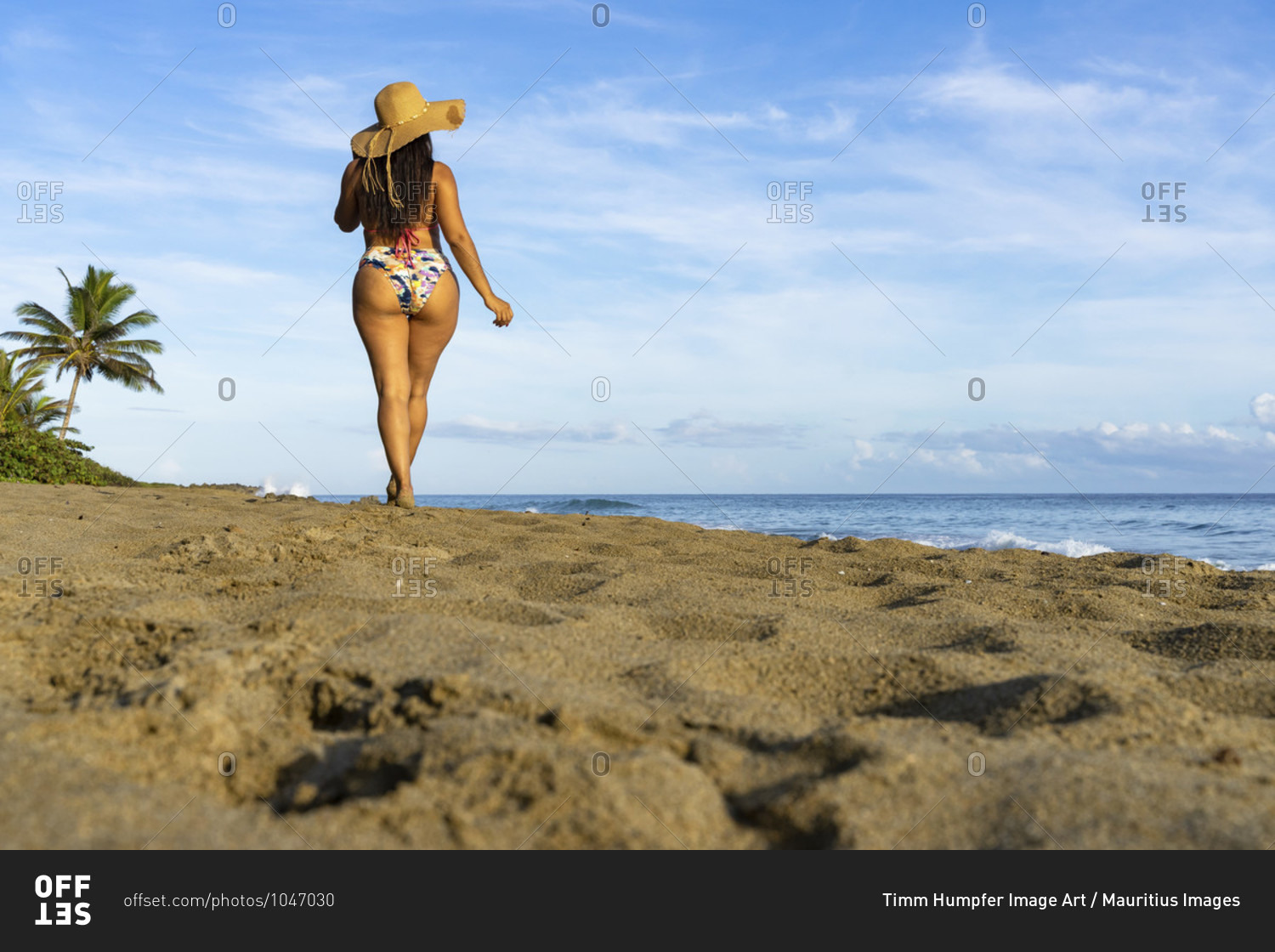 America, caribbean, greater antilles, dominican republic, cabarete, woman strolls along the beach of the natura cabana boutique hotel & spa