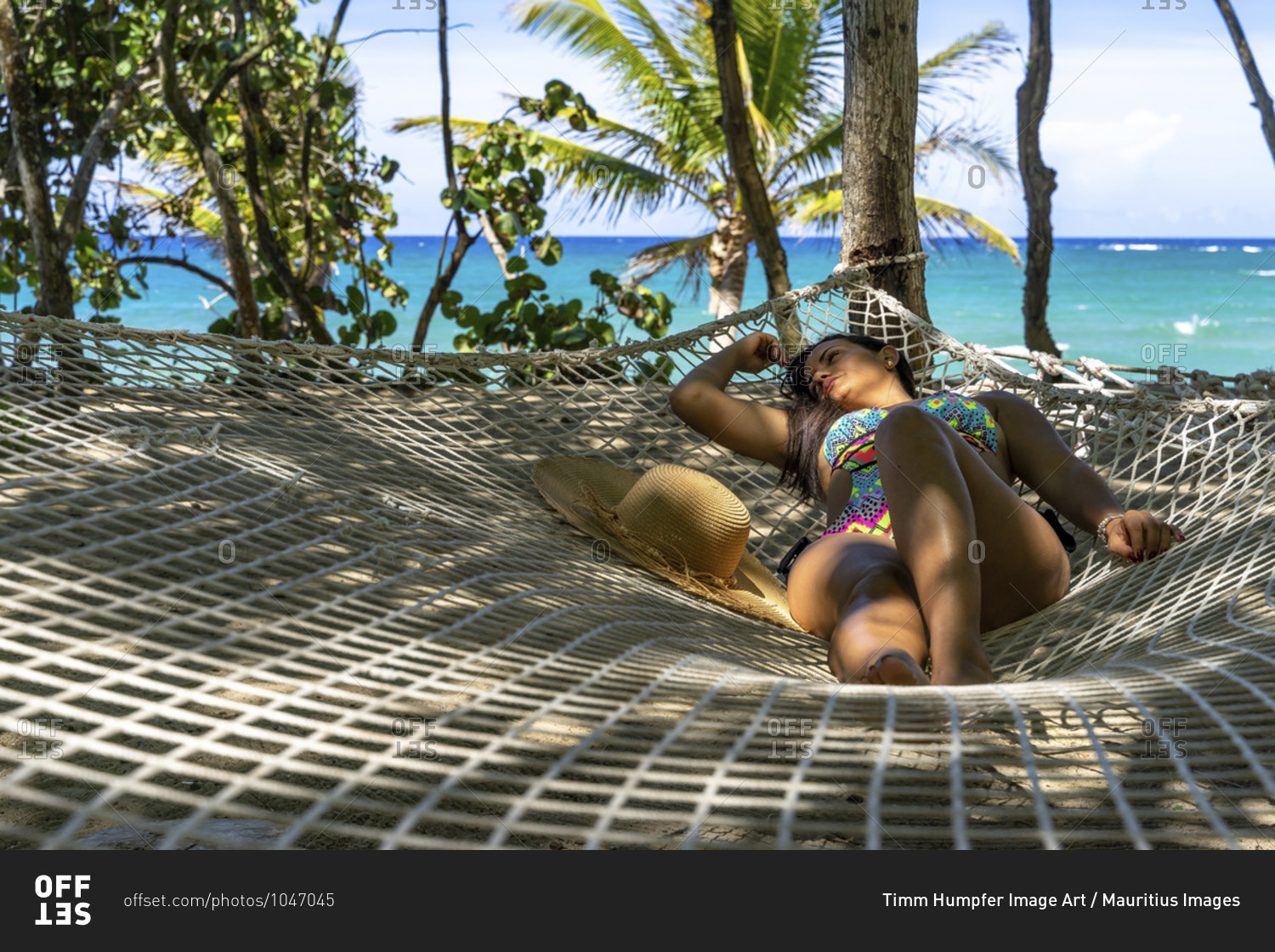 America, caribbean, greater antilles, dominican republic, cabarete, woman relaxing in a hammock at the natura cabana boutique hotel & spa