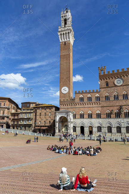 May 9, 2019: Campo with Palazzo Pubblico (town hall) and Torre del Mangia tower, Siena, Tuscany, Italy