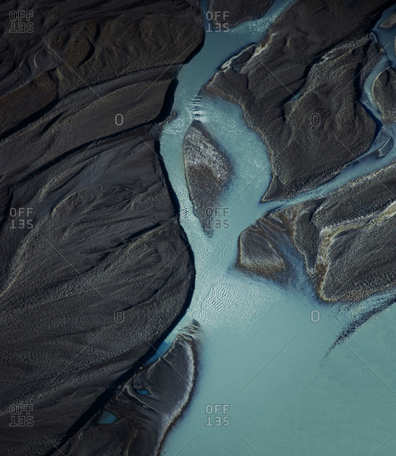Aerial view of blue glacial rivers and textures melting from Tasman Lake and running into Lake Pukaki, Mount Cook National Park, South Island, New Zealand