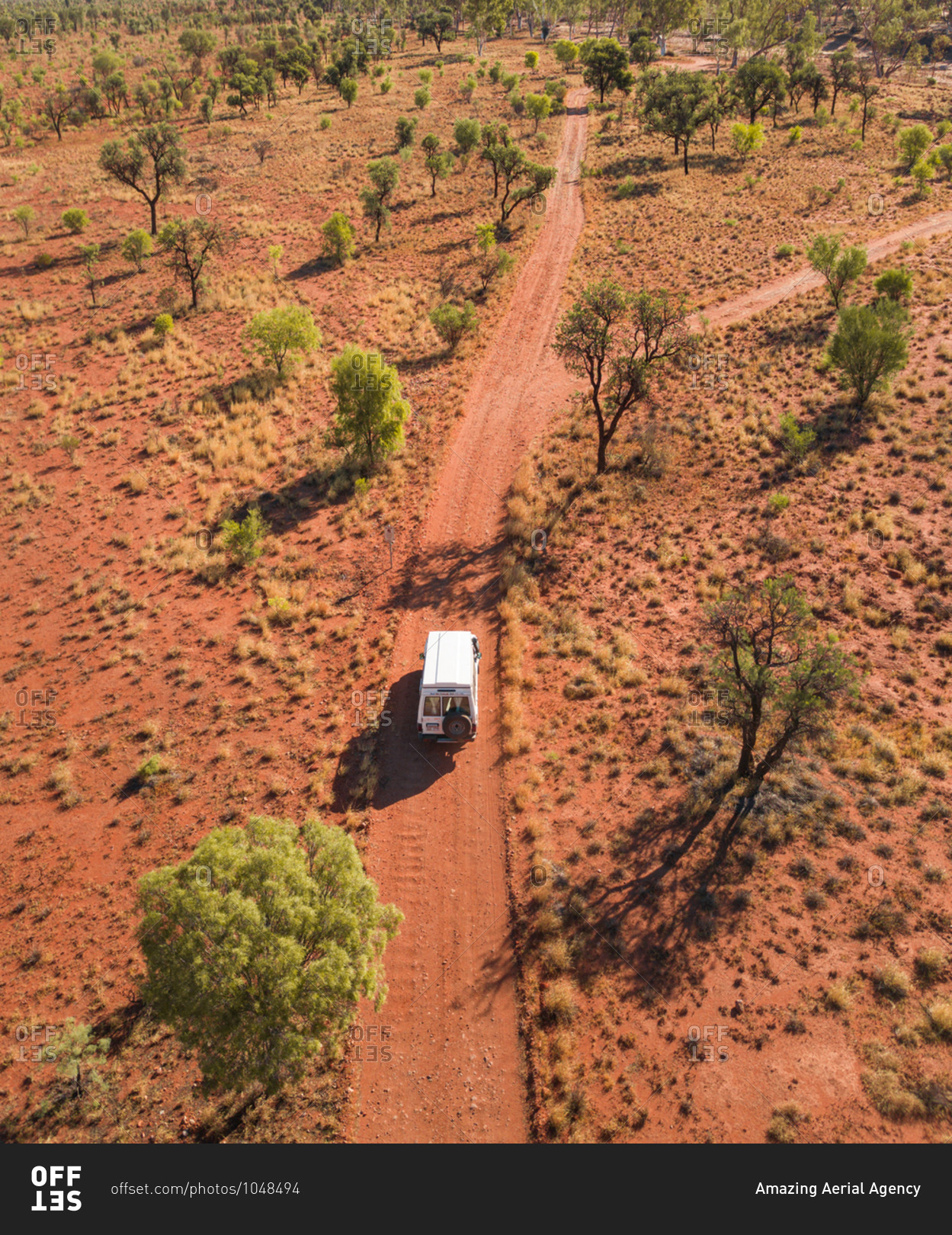 Aerial view of 4x4 truck on off road red dirt track in the outback desert in the Northern Territory, Australia
