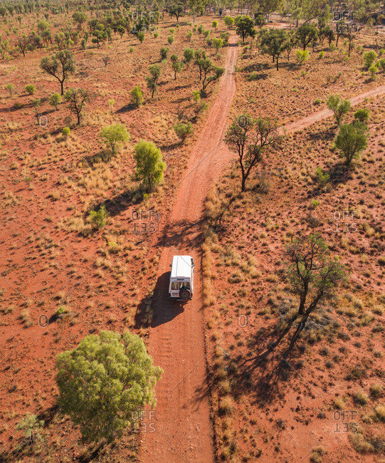 Aerial view of 4x4 truck on off road red dirt track in the outback desert in the Northern Territory, Australia