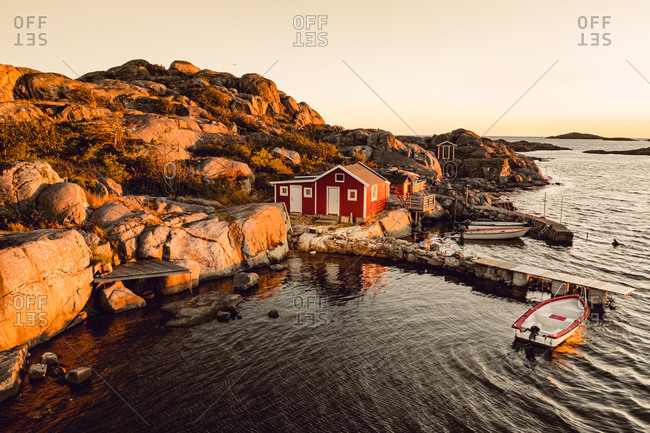 Aerial view of a small bay with red boat houses and boats, Gothenburg Archipelago, Sweden, Scandinavia