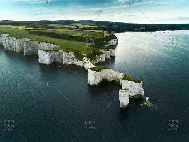 Aerial view of the iconic landmark of Old Harry Rocks and its white cliffs made of chalk in Studland, Dorset, United Kingdom.