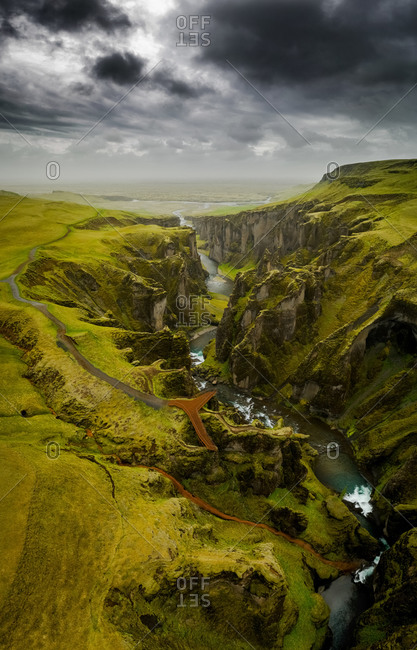 Vertical aerial panorama of metal viewpoint platform at touristic hotspot canyon in the South of Iceland in between Vik and Hof.