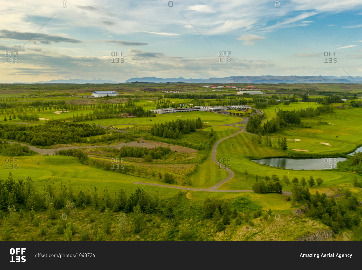 Aerial view of golf course and Icelandair hotel Hamar with mountain view in Borgarnes, Iceland.