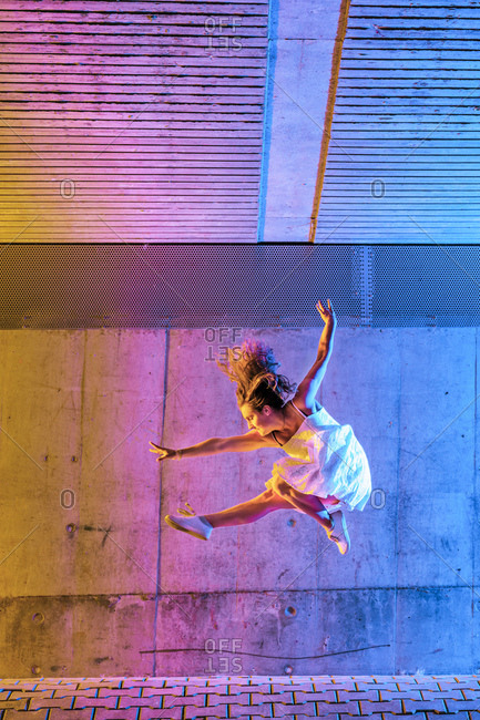 Acrobat dancing against a wall