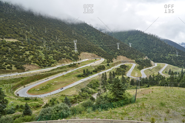 Chengdu-Lhasa Highway, Sichuan, China; August 5, 2019;  The "Nu Jiang 72 Turns" is one of the most famous sections of the winding road along the Sichuan-Tibet Highway. Drivers, passengers, and even thrill-seeking cyclists ascend from 3,100 meters to a breathtaking altitude of 4,658 meters to feast their eyes.