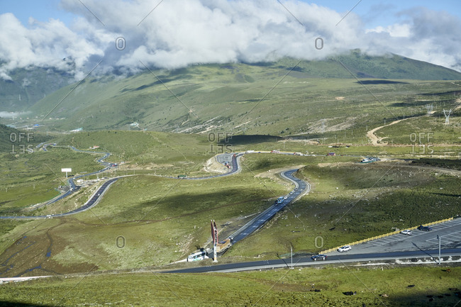 Chengdu-Lhasa Highway, Sichuan, China; August 10, 2019;  The "Nu Jiang 72 Turns" is one of the most famous sections of the winding road along the Sichuan-Tibet Highway. The stunning sight is between the counties of Basu and Bangda. Drivers, passengers, and even thrill-seeking cyclists ascend from 3,100 meters to a breathtaking altitude of 4,658 meters to feast their eyes.