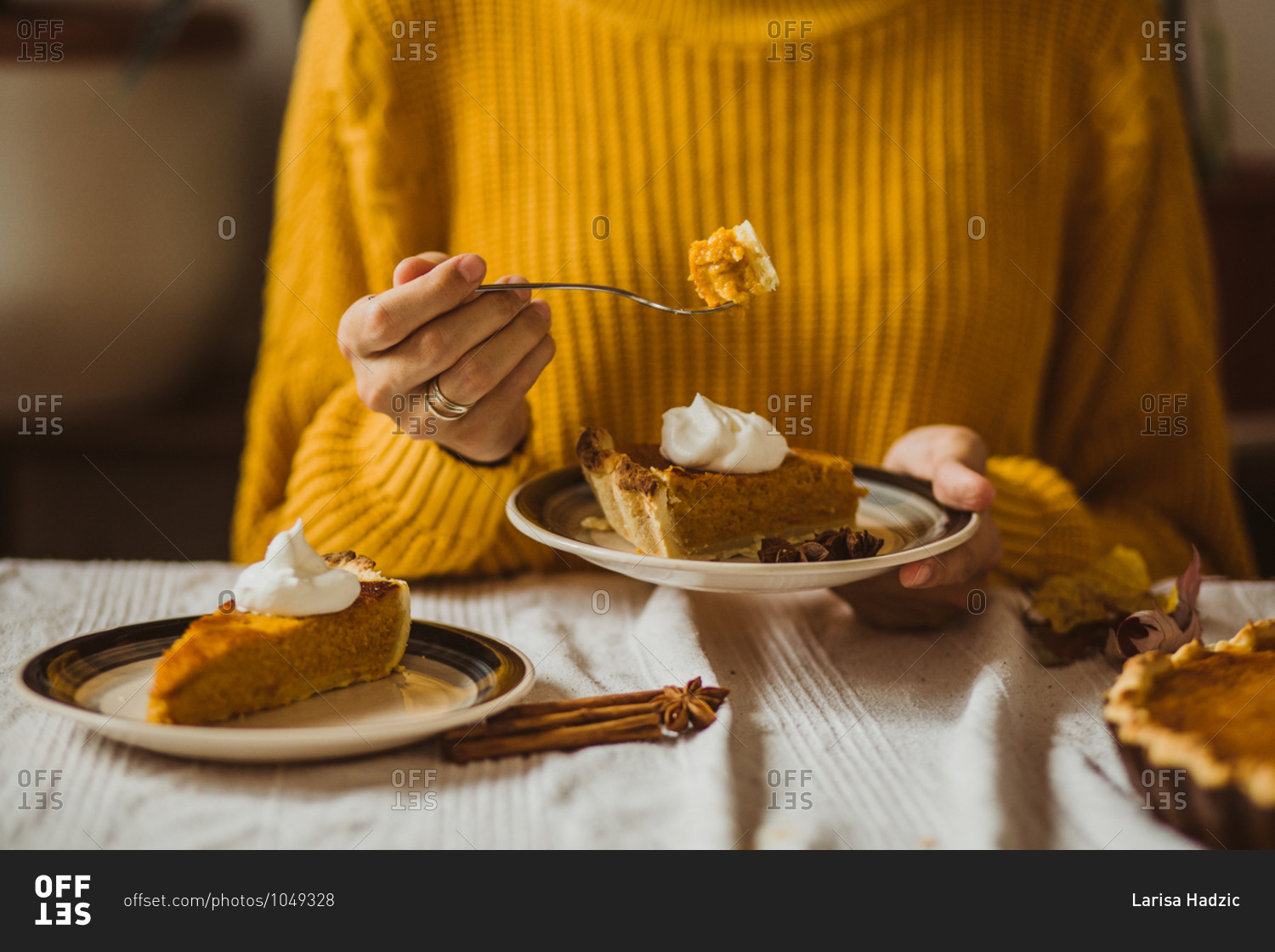 Woman taking a bite of pumpkin pie