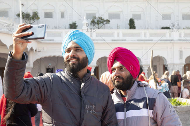 Amritsar, India - January 6, 2020: Worshippers at the Sri Harmandir Sahib temple taking a selfie