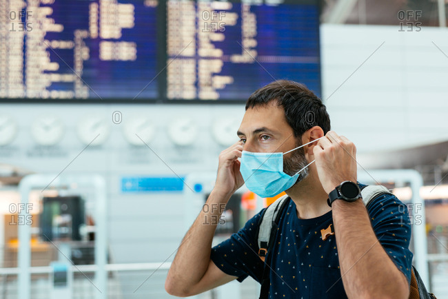Young man wearing a face mask at the airport