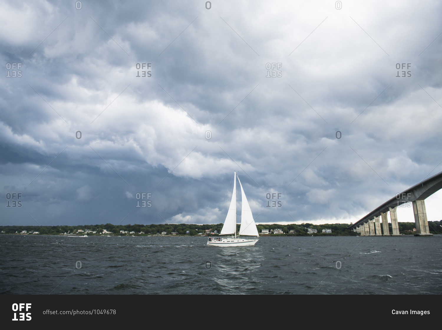 Dark storm encompassing boat on the ocean stock photo -\
OFFSET