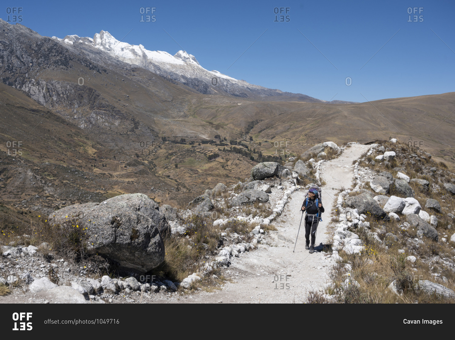 Woman hiker with backpack hiking in Cordillera Blanca, Peru, A