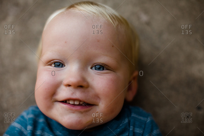 Close up of one year old boy laying on ground in san diego