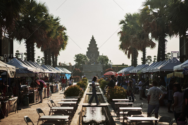 Buriram, Thailand - February 22, 2020: Shopping stalls line the walkway at Buriram Castle with makeshift Khmer ruins as a backdrop