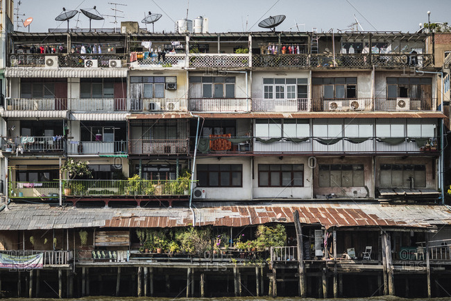 Bangkok, Thailand - April 5, 2019: Houses on stilts in the water along the Chao Phraya river in Bangkok