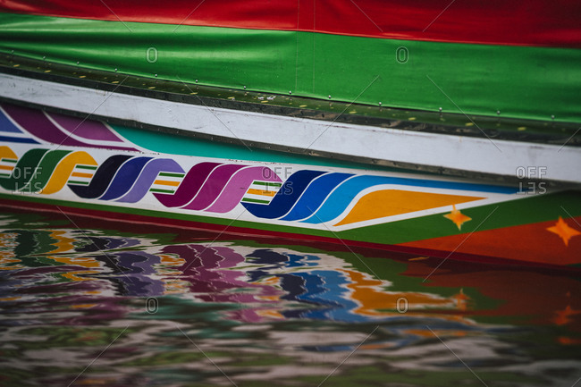 A colorful painted boat bottom reflected in the Chao Phraya river in Bangkok, Thailand