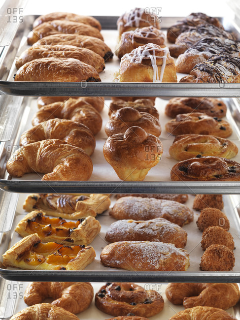 Four sheet pans of beautiful baked pastries ready to eat.