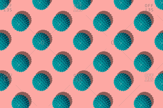 Teal balls arranged on colored background