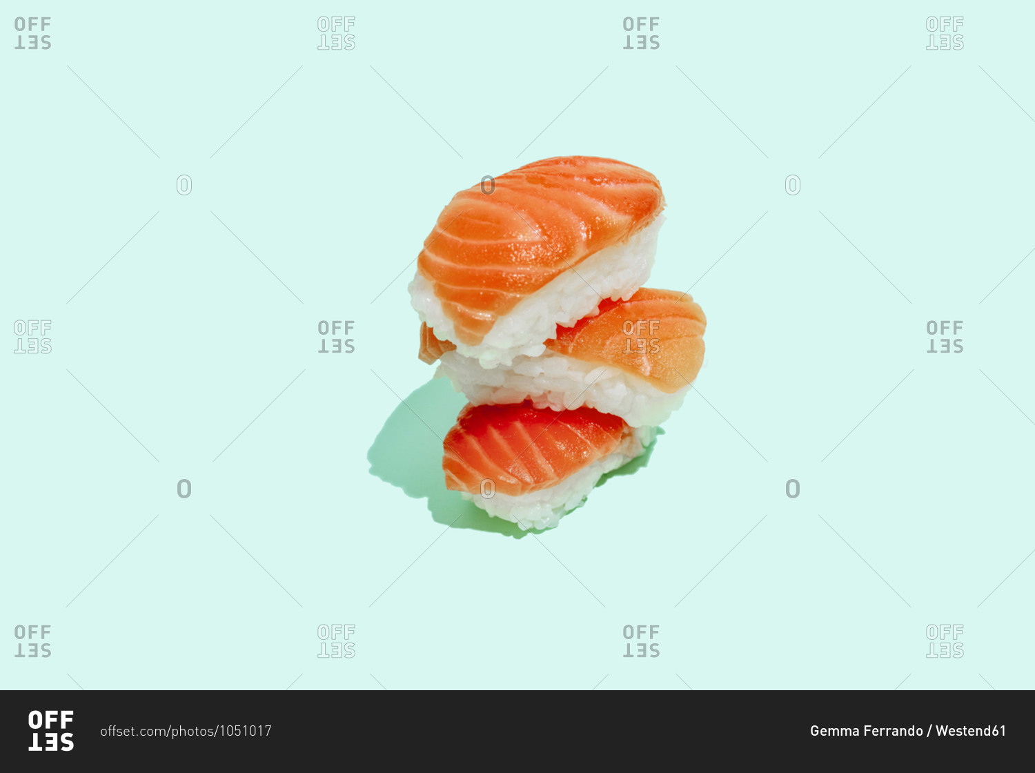 Fresh salmon sushi nigiri on mint green background