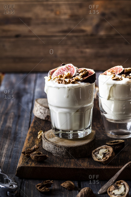 Two glasses of Greek yogurt with honey- figs and walnuts