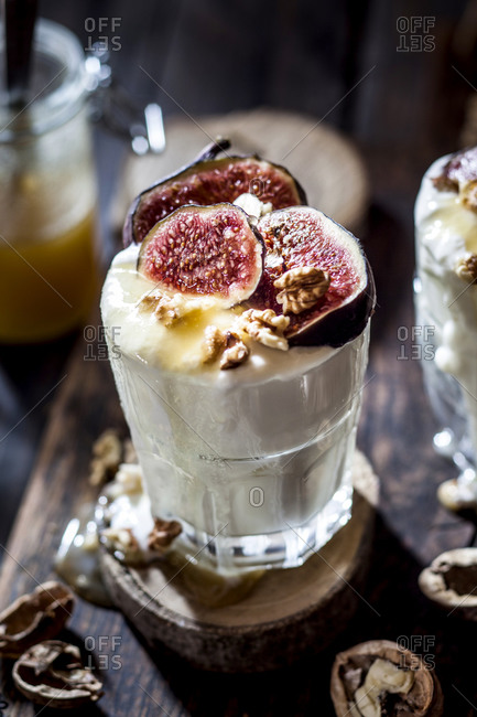 Glass of Greek yogurt with honey- figs and walnuts