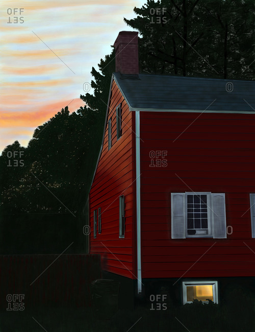 Wooden red house in countryside at sunset