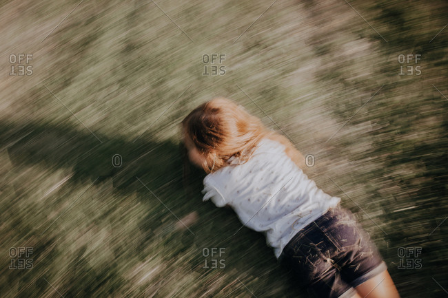 Overhead view of a girl spinning on ground