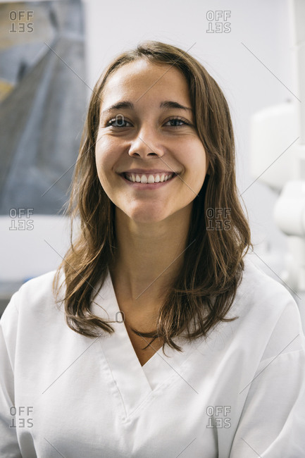 Smiling beautiful female dentist assistant in dental clinic