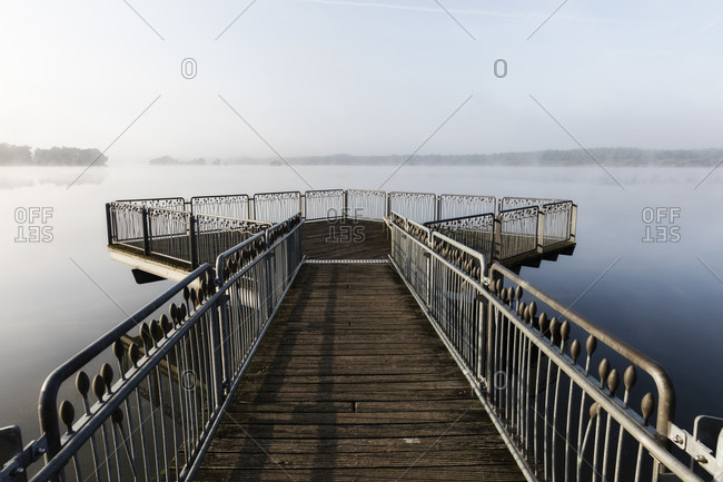Germany- Lower Saxony- Empty observation platform on shore of Thulsfelder Talsperre reservoir during foggy weather