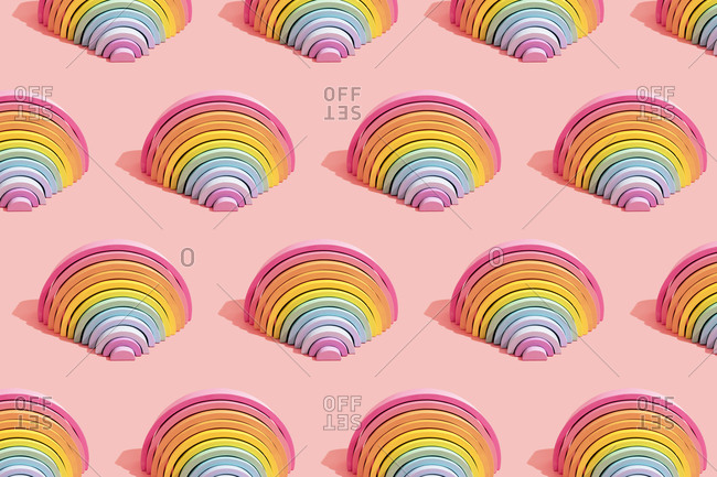 Multiple image of colorful rainbow toys on pink background