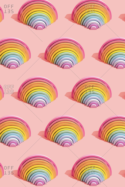 Multiple image of colorful rainbow toys on colored background