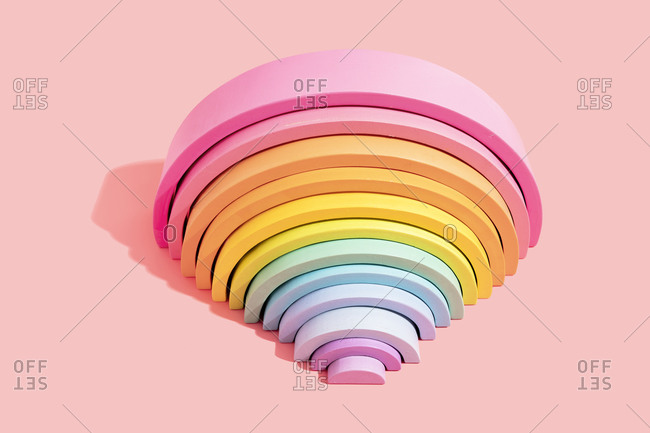Close-up of colorful rainbow toy on pink background