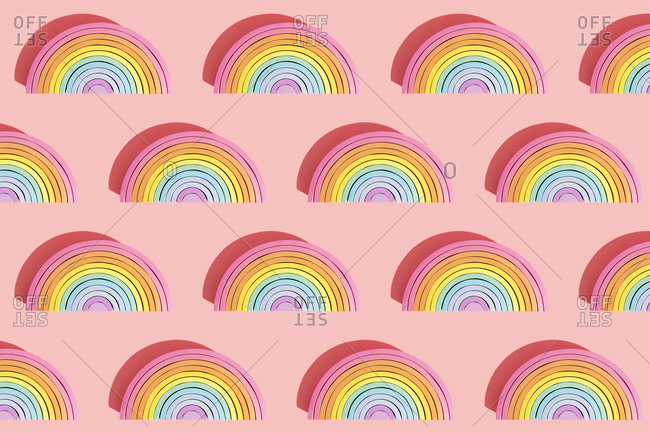 Multiple image of colorful wooden rainbow toys on pink background