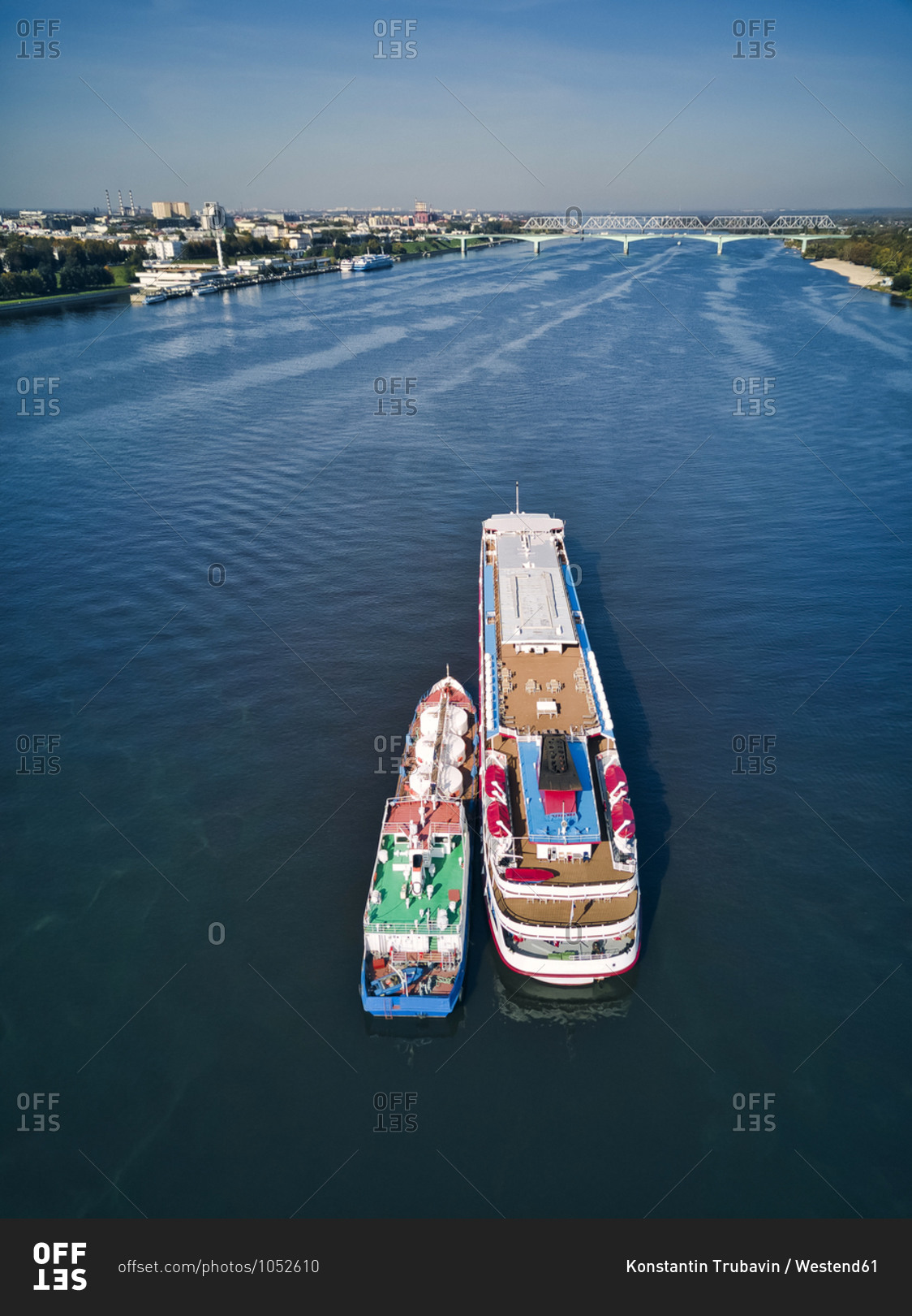 Barge refueling recreational boat on Volga River against sky