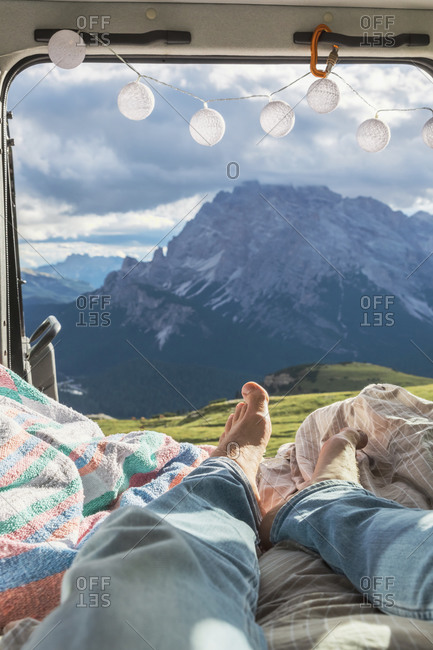 Man relaxing in campervan against mountain range- Sesto Dolomites- Dolomites- Alto Adige- Italy