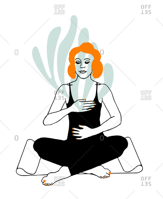 Woman sitting on yoga mat in lotus position doing breathing exercises