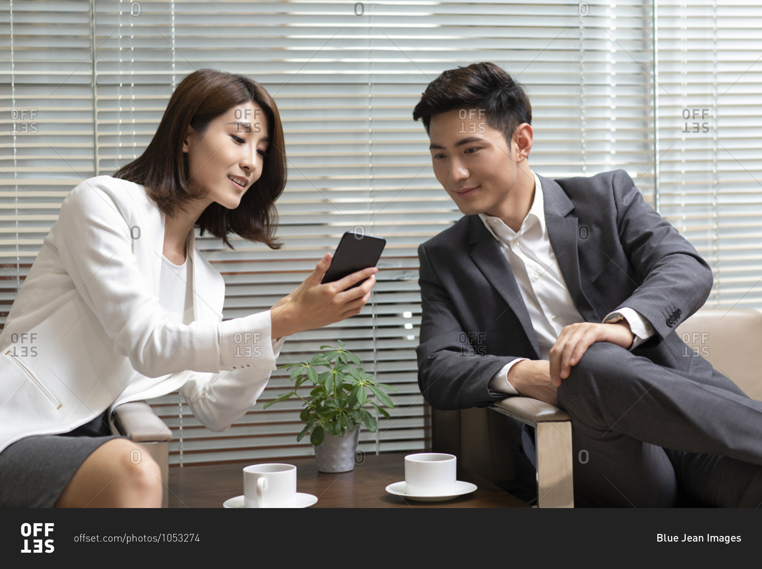 Chinese business people using smartphone in office