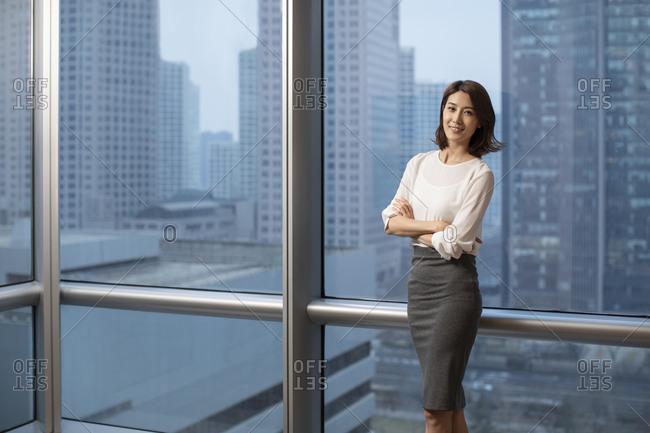 Confident Chinese businesswoman in office