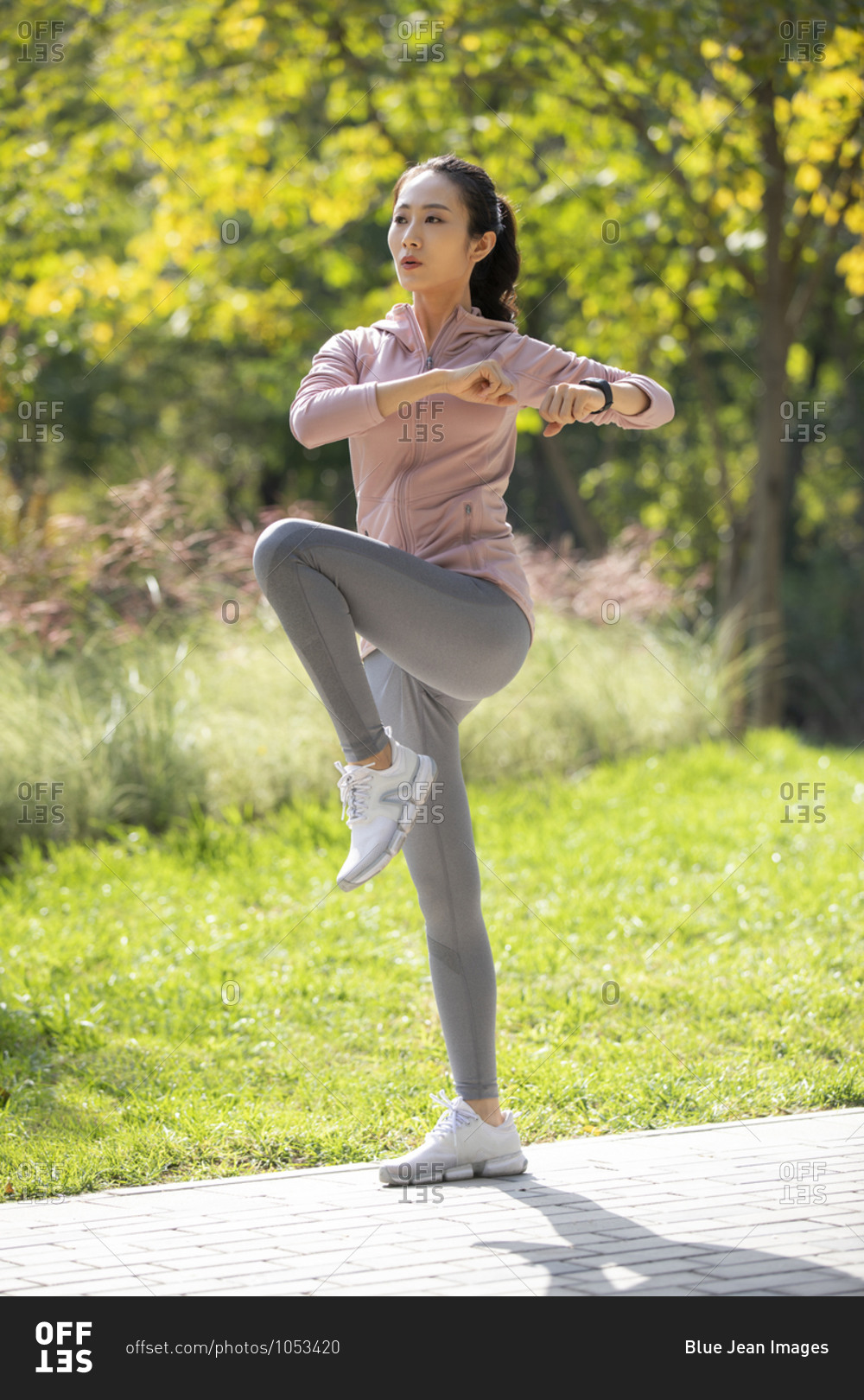 Young Chinese woman exercising in park