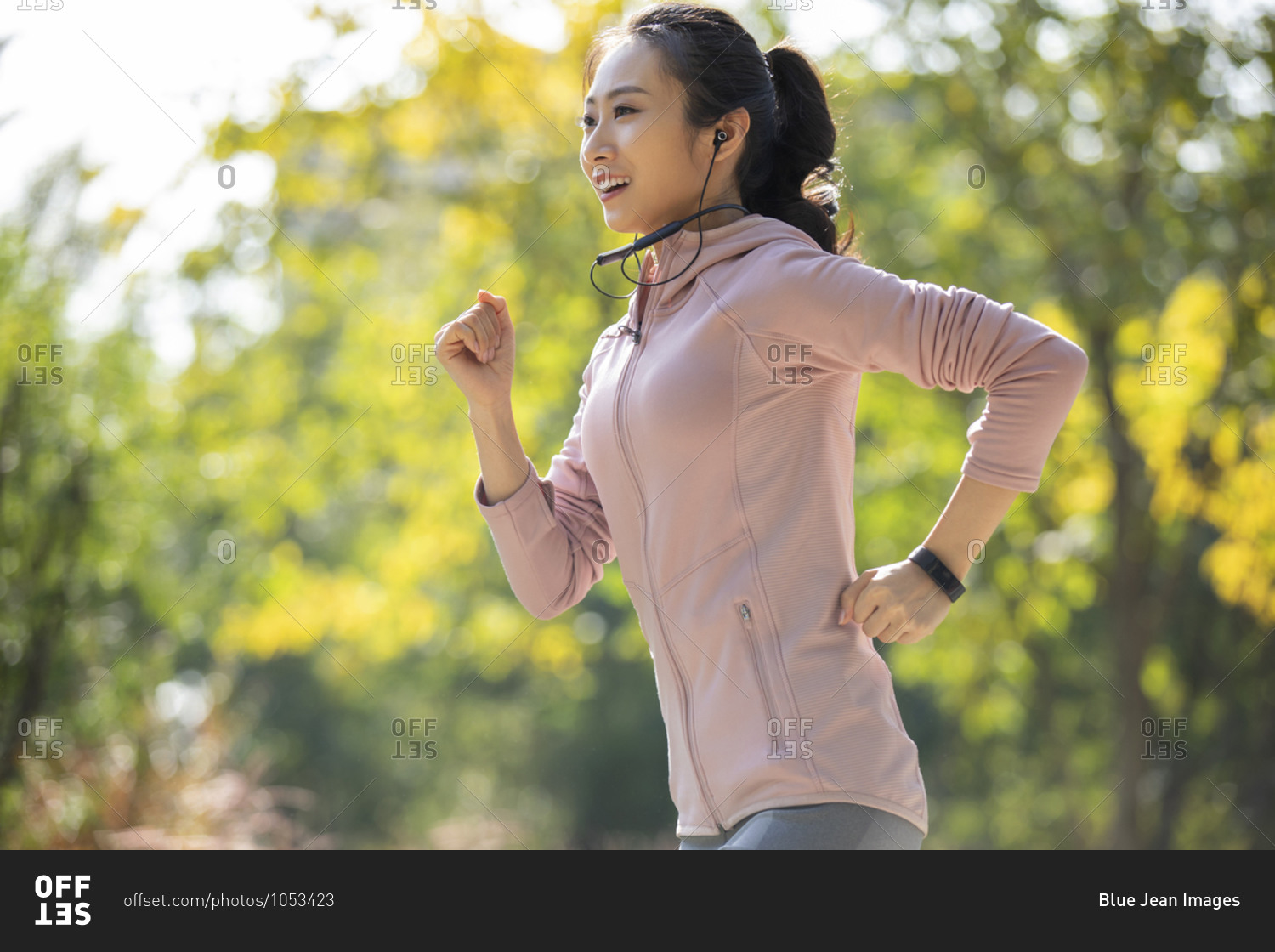 Young Chinese woman jogging in park
