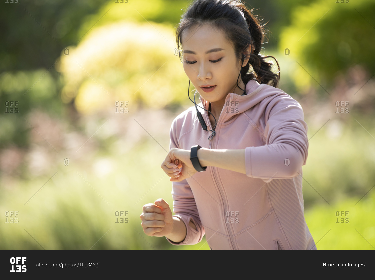 Young Chinese woman checking smart watch