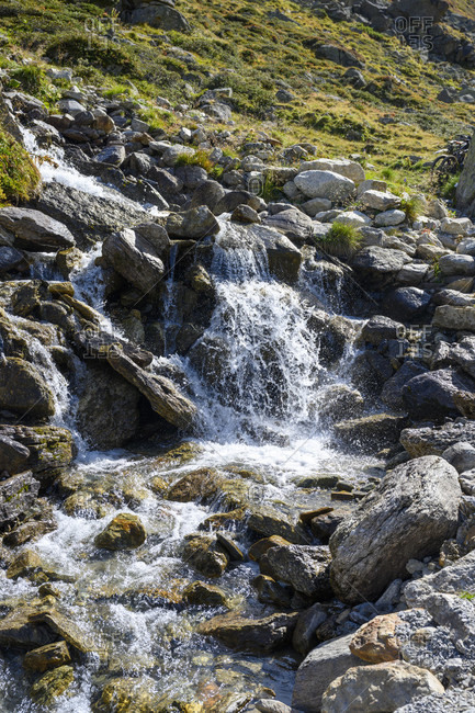 Austria, montafon, small waterfall at lake silvretta.