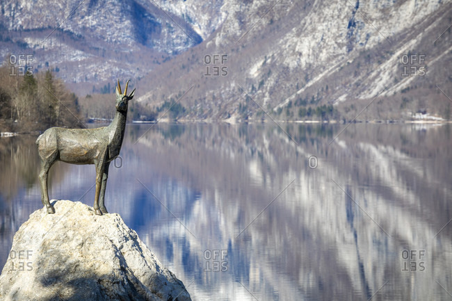 March 8, 2020: bohinj lake, the statue of zlatarog, the legendary chamois with golden horns, ribcev laz, upper carniola, triglav national park, slovenia