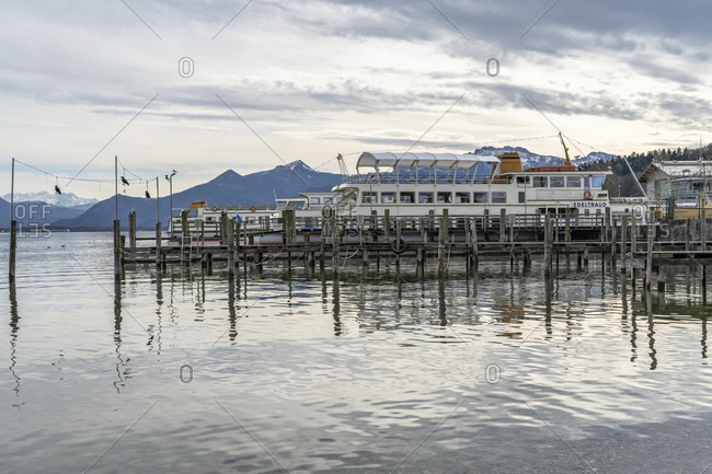February 17, 2020: europe, Germany, bavaria, rosenheim, prien am chiemsee, chiemsee, boat dock in priem am chiemsee with the chiemgau alps in the background