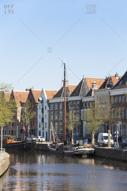 April 19, 2019: view of the canals with the old traditional sailing ships and the historic houses in the city center of groningen, netherlands