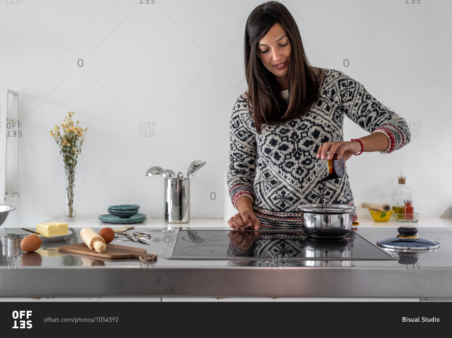 Woman cooking some gingerbread men at bright kitchen